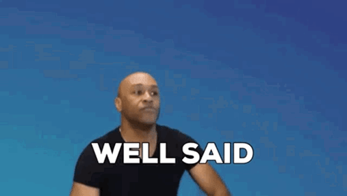 A Man In A Black Shirt Is Clapping His Hands And Saying Well Said . GIF