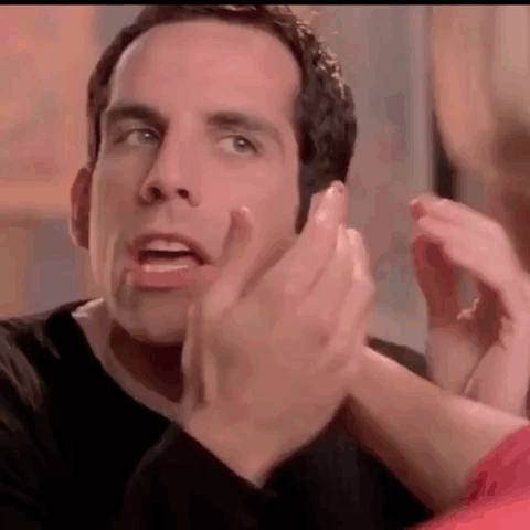 A Man In A Black Shirt Is Clapping His Hands In A Close Up Of His Face . GIF
