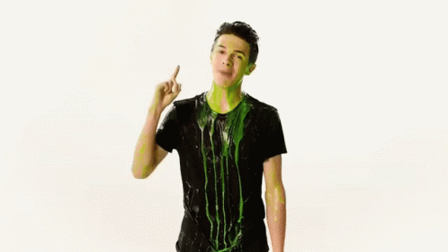 A Man In A Black Shirt Is Covered In Green Slime And Dancing . GIF