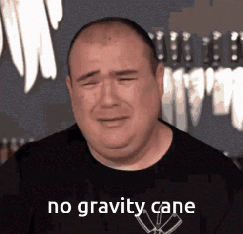 A Man In A Black Shirt Is Crying With The Words No Gravity Cane Above Him GIF