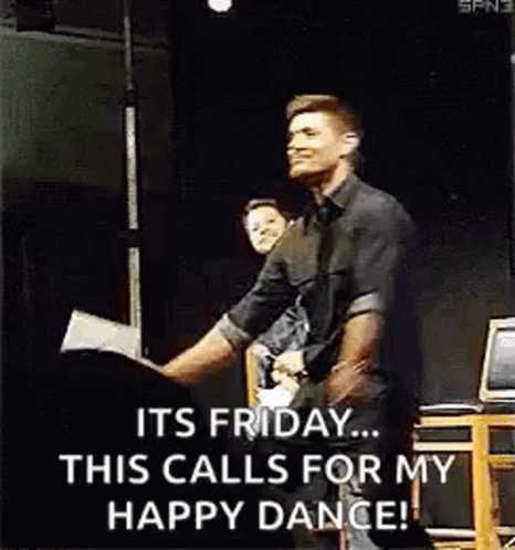 A Man In A Black Shirt Is Dancing On A Stage . GIF