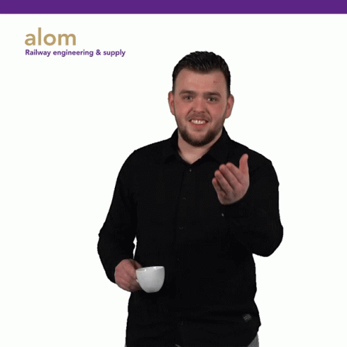 A Man In A Black Shirt Is Holding A Cup Of Coffee In Front Of A Sign That Says Alom GIF