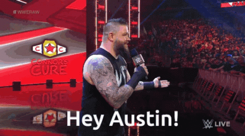 Man In Black Shirt Holding Microphone Saying Hey Austin GIF