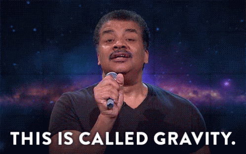 A Man In A Black Shirt Is Holding A Microphone In His Hand And Says This Is Called Gravity . GIF