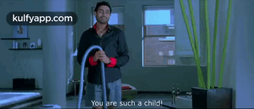 A Man In A Black Shirt Is Holding A Vacuum Cleaner And Says You Are Such A Child . GIF