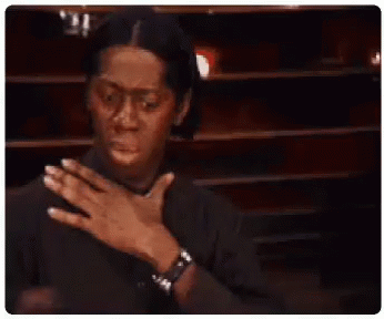 A Man In A Black Shirt Is Holding His Chest With His Hands . GIF