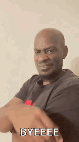 A Man In A Black Shirt Is Making A Funny Face And Says `` Byeeee '' . GIF