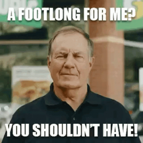 A Man In A Black Shirt Is Making A Funny Face While Standing In Front Of A Subway Sign . GIF