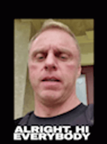 A Man In A Black Shirt Is Making A Funny Face With The Words `` Alright Hi Everybody '' Above Him . GIF