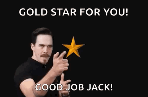 A Man In A Black Shirt Is Pointing At Two Gold Stars With His Fingers . GIF