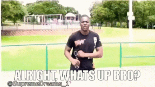 A Man In A Black Shirt Is Running In A Park And Says Alright Whats Up Bro ? GIF