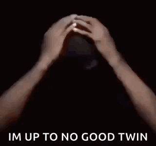 A Man In A Black Shirt Is Saying `` Im Up To No Good Twin '' In A Dark Room . GIF