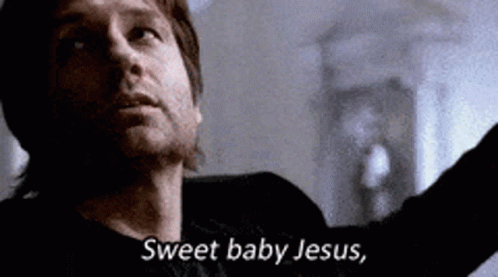 A Man In A Black Shirt Is Saying `` Sweet Baby Jesus '' While Looking Up . GIF