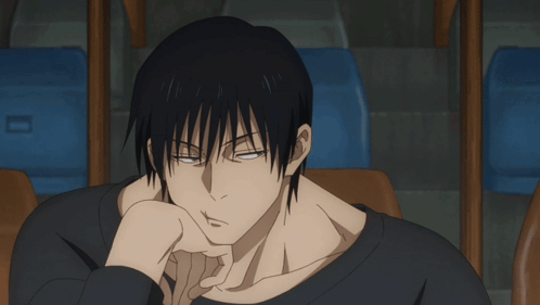 A Man In A Black Shirt Is Sitting In A Chair GIF