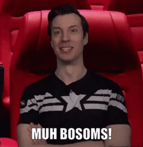 A Man In A Black Shirt Is Sitting In A Red Chair With His Arms Crossed And Says Muh Bosoms ! GIF