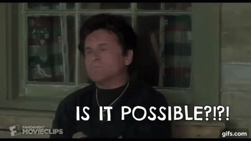 A Man In A Black Shirt Is Sitting In Front Of A Window . GIF