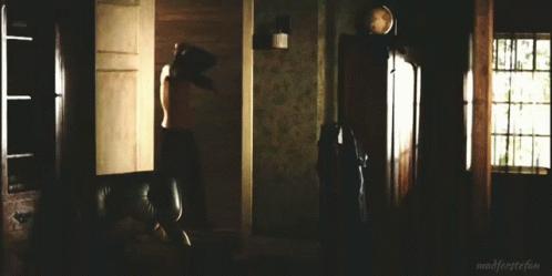 A Man In A Black Shirt Is Standing In A Dark Room With The Words Madforeststefan Written On The Bottom GIF
