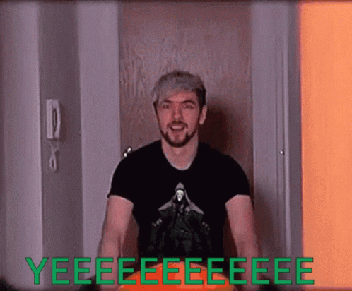 A Man In A Black Shirt Is Standing In Front Of A Door That Says Yeee GIF