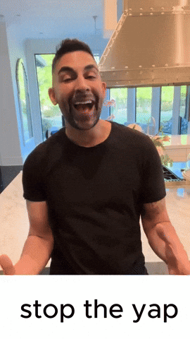A Man In A Black Shirt Is Standing In Front Of A Stove With The Words " Stop The Yap " Below Him GIF