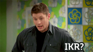 A Man In A Black Shirt Is Standing In Front Of A Wall With Flowers On It And Says Ikr GIF