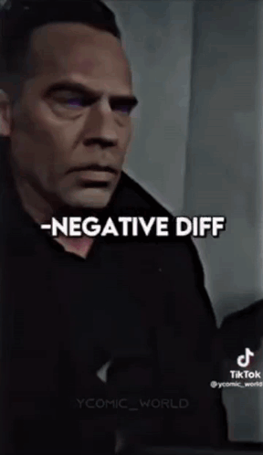 A Man In A Black Shirt Is Standing In Front Of A Wall With The Words `` Negative Diff '' Written On It . GIF