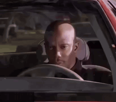 A Man In A Black Shirt Is Standing Next To A Police Officer . GIF