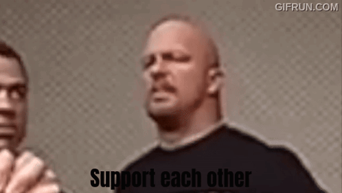A Man In A Black Shirt Is Standing Next To Another Man With The Words Support Each Other On The Bottom . GIF