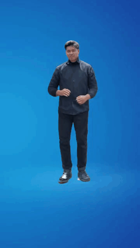 A Man In A Black Shirt Is Standing On A Blue Background GIF