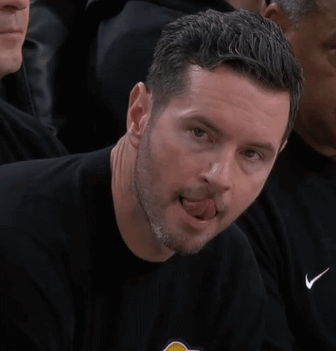A Man In A Black Shirt Is Sticking His Tongue Out . GIF