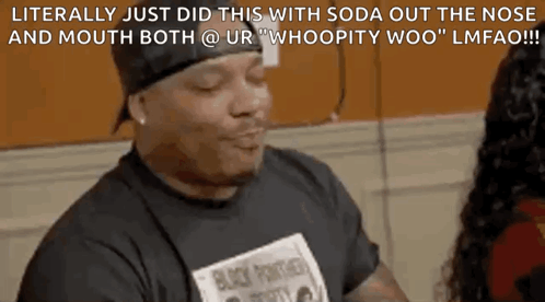 A Man In A Black Shirt Is Talking To A Woman In A Room . GIF