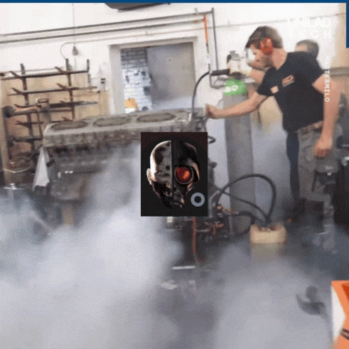 A Man In A Black Shirt Is Working On A Machine With A Picture Of A Terminator On It GIF