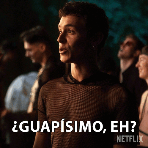 A Man In A Black Shirt Says " Guapisimo Eh " In Front Of A Crowd GIF