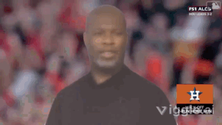 A Man In A Black Shirt Stands In Front Of An Orange H Logo GIF