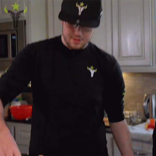 A Man In A Black Shirt With A Bull On The Front GIF