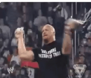 A Man In A Black Shirt With The Word Destroyo On It Is Raising His Fist In The Air In Front Of A Crowd . GIF