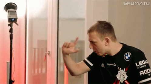 A Man In A Black Shirt With The Word Logitech On It Is Standing In Front Of A Microphone . GIF