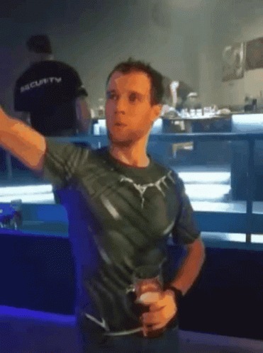 A Man In A Black Shirt With The Word Security On His Back GIF