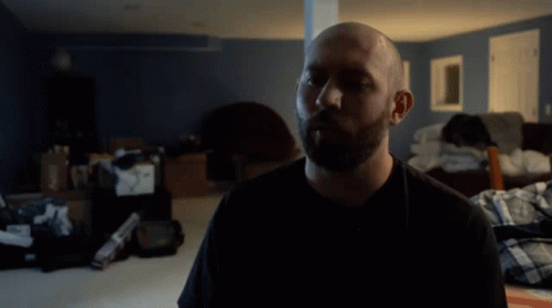 A Man In A Black Shirt With The Word Water Behind Him GIF