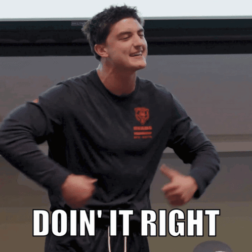 A Man In A Black Shirt With The Words Doin ' It Right On It GIF