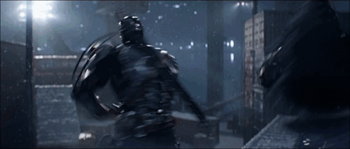 A Man In A Black Suit Is Fighting Another Man GIF