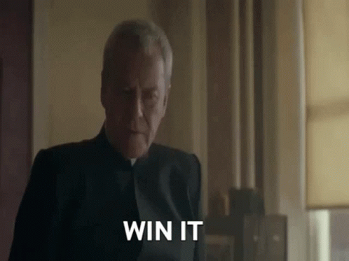 A Man In A Black Suit Is Saying " Win It " GIF