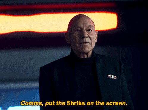 A Man In A Black Suit Says Comms Put The Shrike On The Screen GIF