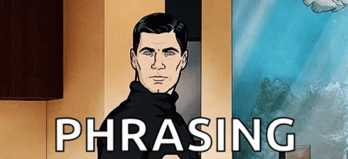 A Man In A Black Sweater Is Standing In Front Of A Wall With The Word Phrasing On It . GIF