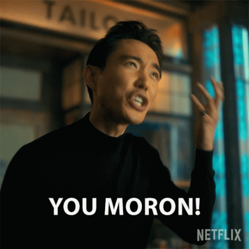A Man In A Black Sweater Says " You Moron " GIF