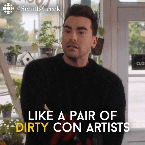 A Man In A Black Sweater With The Words Like A Pair Of Dirty Con Artists On The Bottom GIF