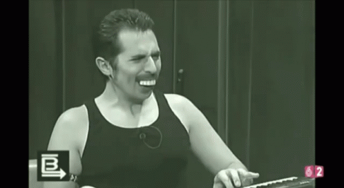 A Man In A Black Tank Top Is Screaming In A Black And White Photo With The Letters B And 2 In The Corner GIF