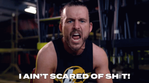 A Man In A Black Tank Top Is Screaming With The Words I Ain 'T Scared Of Shit Below Him GIF