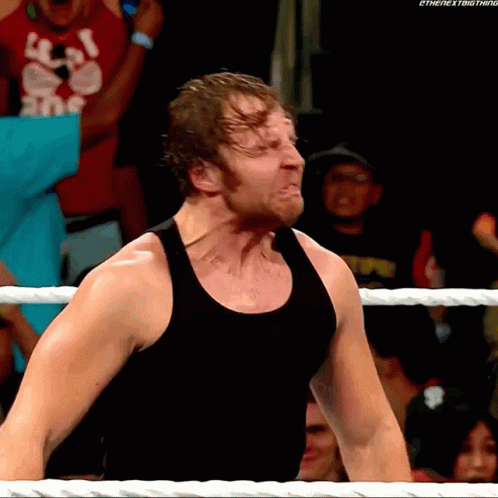 A Man In A Black Tank Top Is Standing In A Wrestling Ring With The Next Thing Written On The Bottom GIF