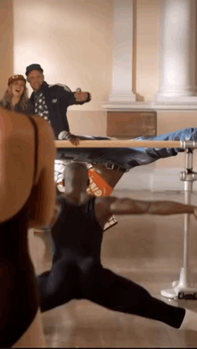 A Man In A Black Tank Top With The Word Elf On The Back Is Dancing GIF