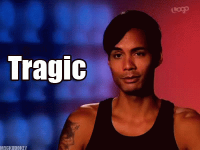 A Man In A Black Tank Top With The Word Tragic Written On It GIF